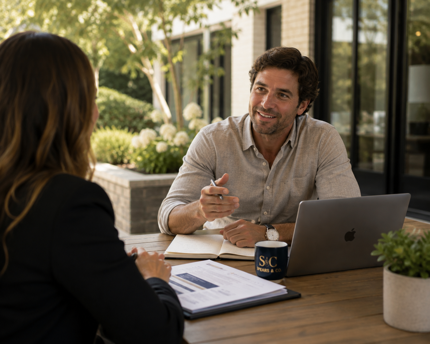 Advisor and client in a candid business conversation at an outdoor table